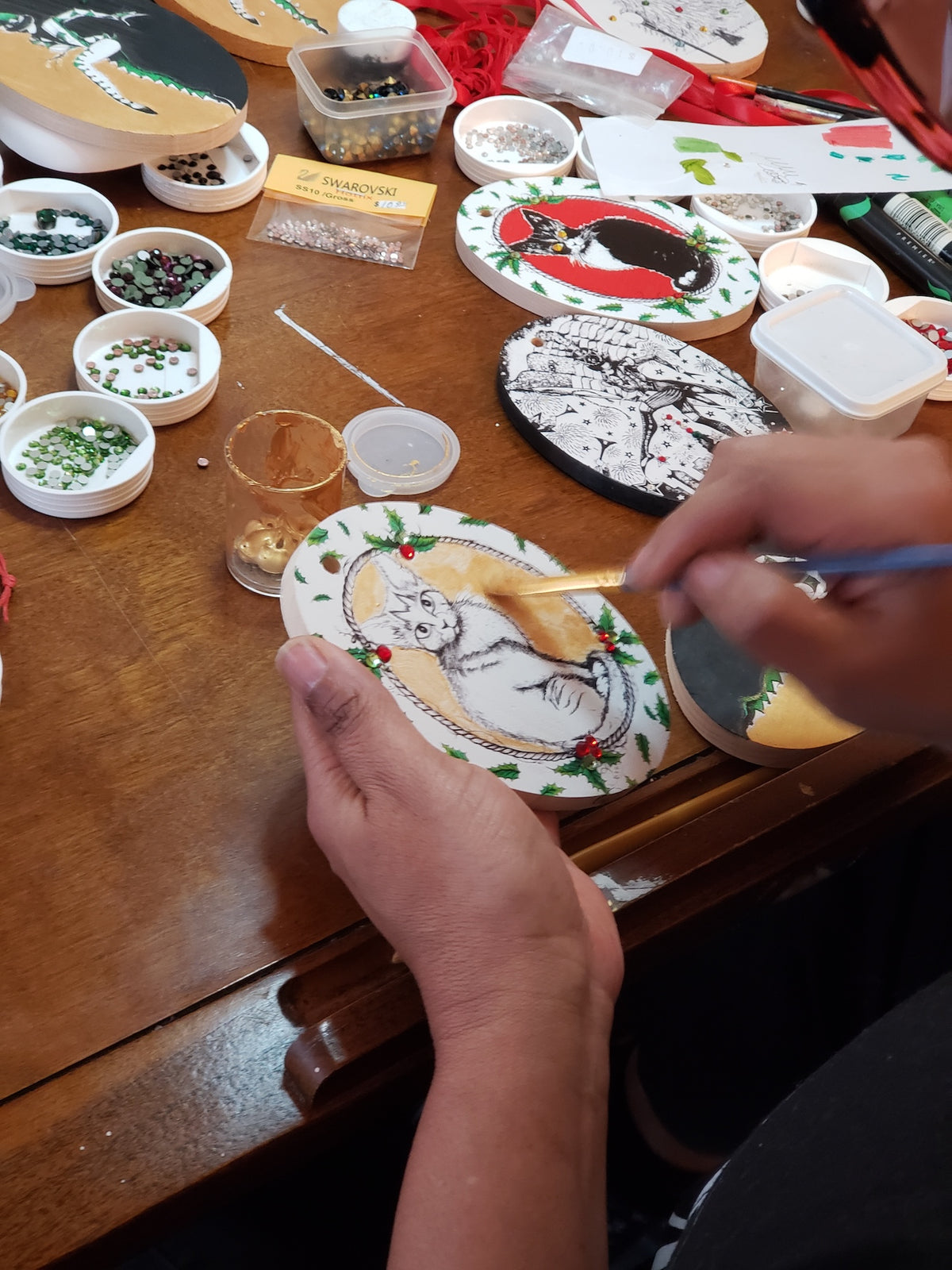 Martha Colón hands painting white cat holiday wood ornament gold background Swarovski crystals studio NYC handmade
