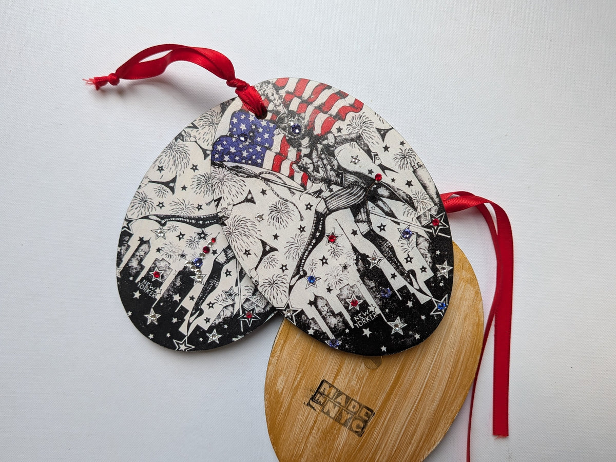 nyc skyline with meowcleeva marching on the 4th of July holing the American flag ornament with Swarovski crystal