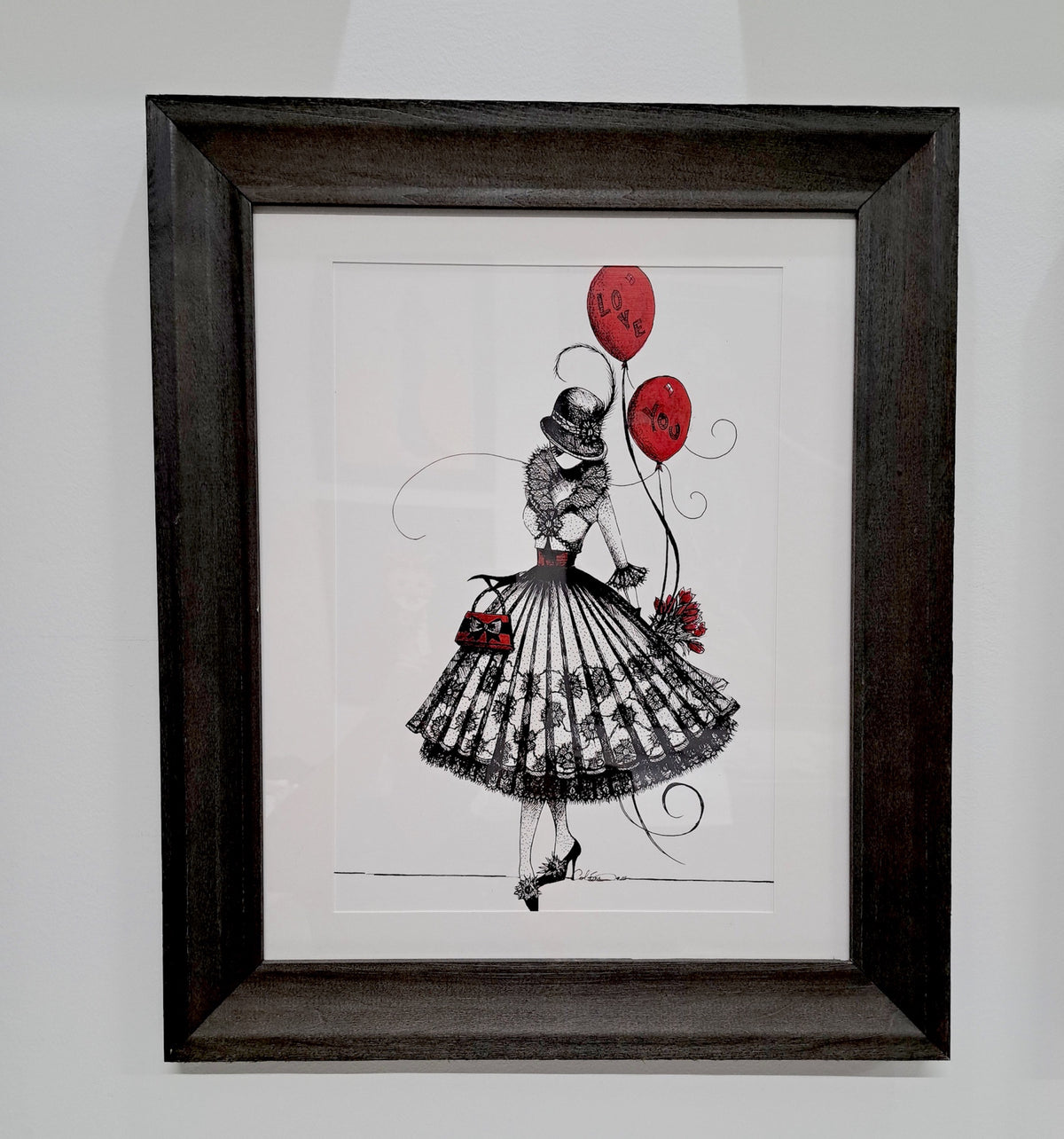 Framed artwork of a fashion lace dress illustration of the character MeowCleeva with red balloons by Martha Colón
