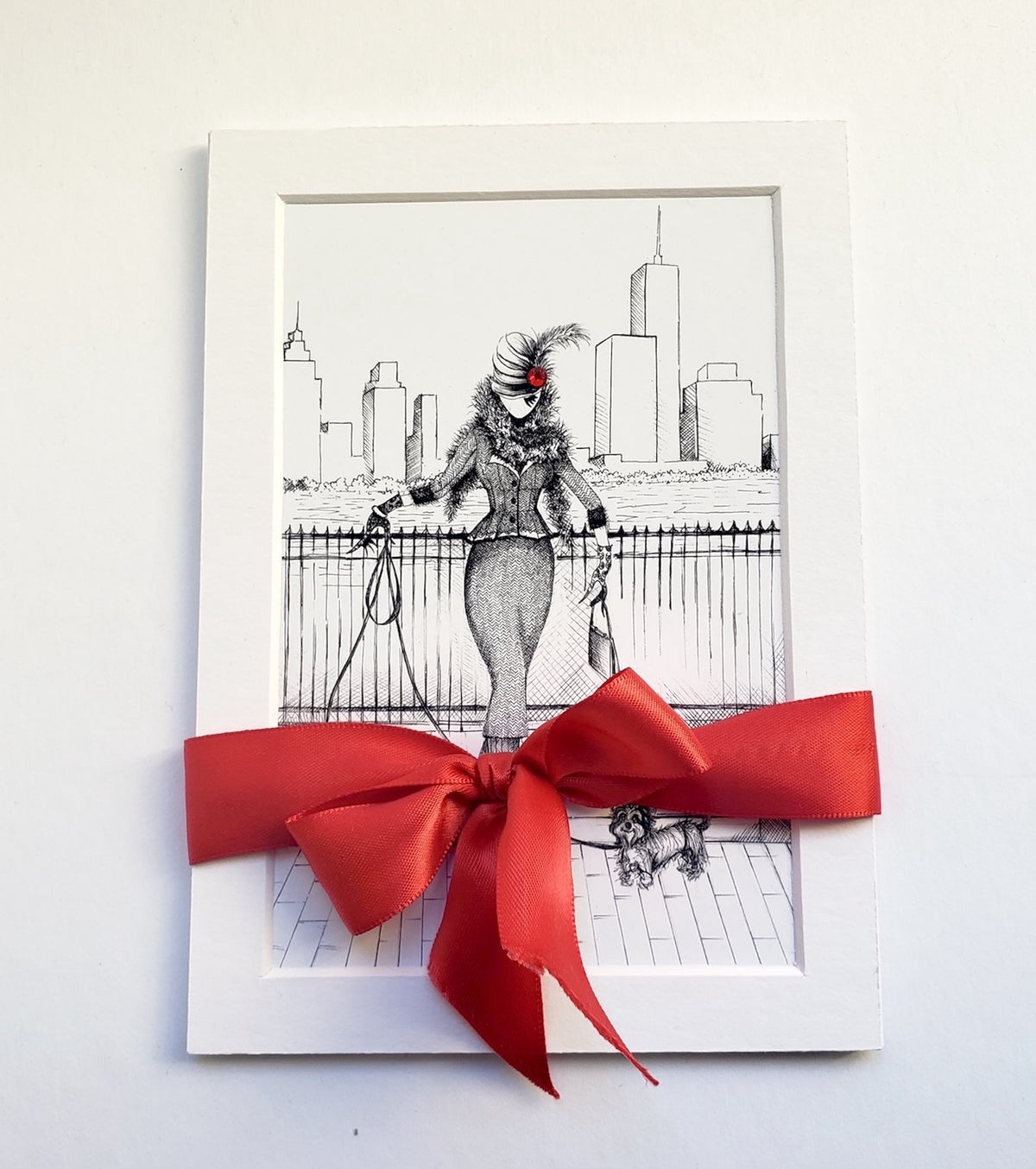 A Herringbone Morning 5x7 matted art print, MeowCleeva in a herringbone suit with two Yorkies and the NYC skyline, tied with red satin ribbon