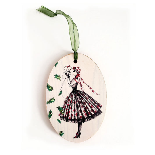 Hand painted wood ornament featuring MeowCleeva® in her iconic rose print dress, adorned with Swarovski crystals. Holly border, gold ribbon. One of a kind. $125.