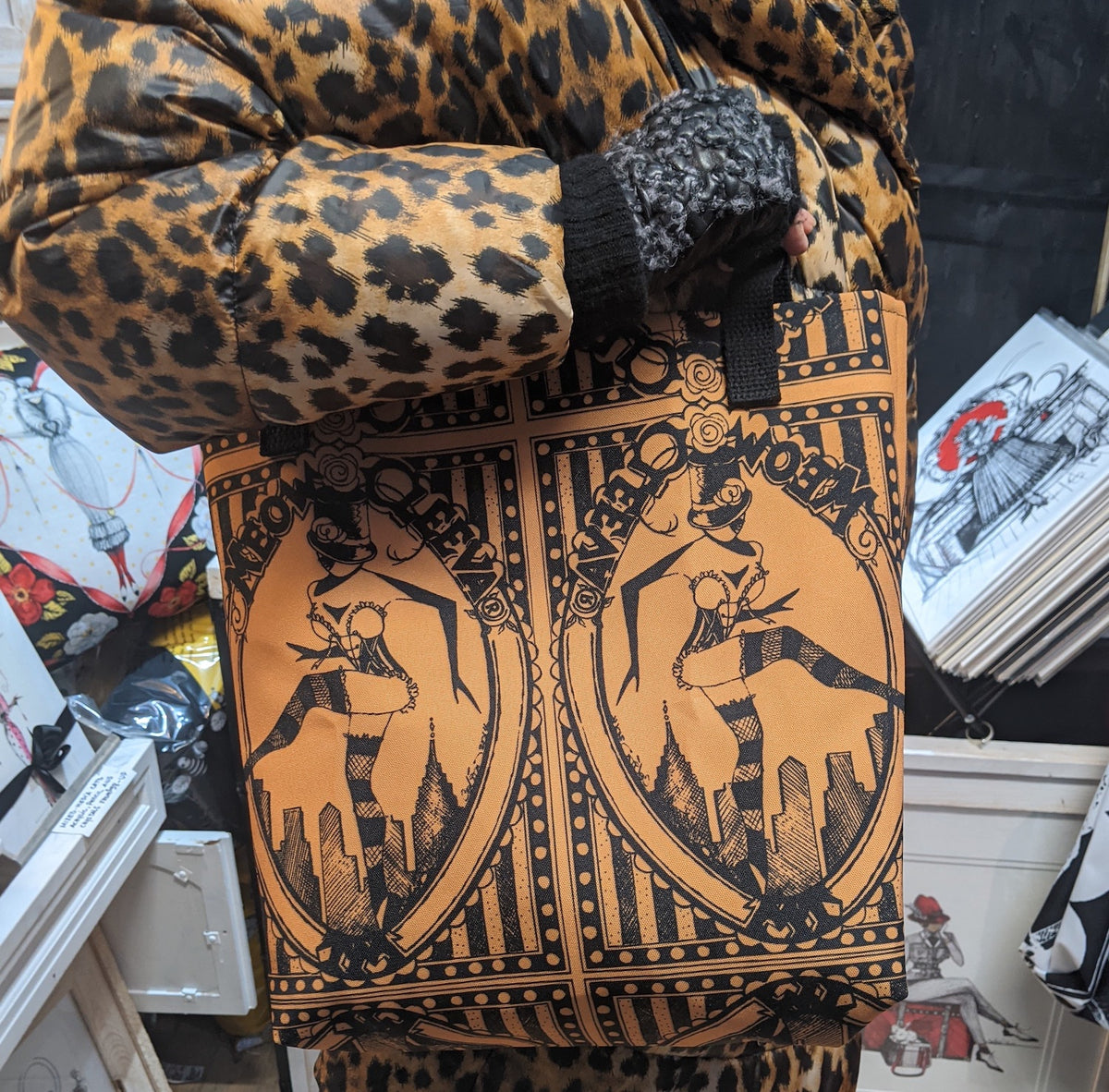 Leopard print bag with meowcleeva graphic design in an art shop 